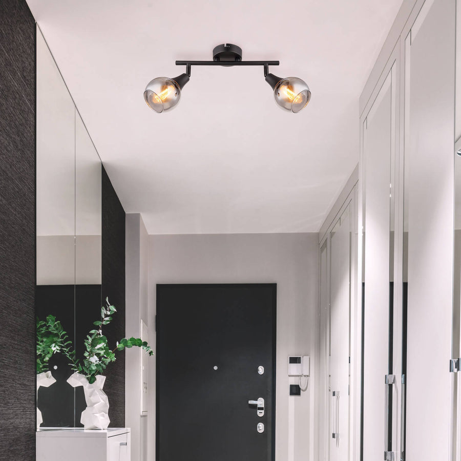 Spot double noir mat installé au plafond dans une entrée moderne