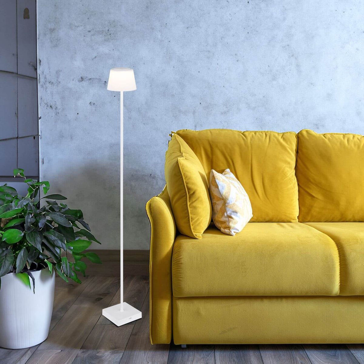 Mise en ambiance salon, lampadaire près d'un canapé jaune et d'une plante