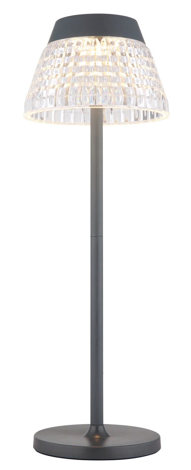Vue de face du luminaire sans fil, abat-jour clair et socle circulaire sombre.