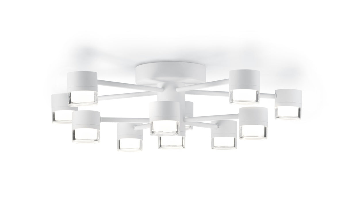 Vue en perspective du luminaire fixé au plafond, structure blanche et diffuseurs cylindriques