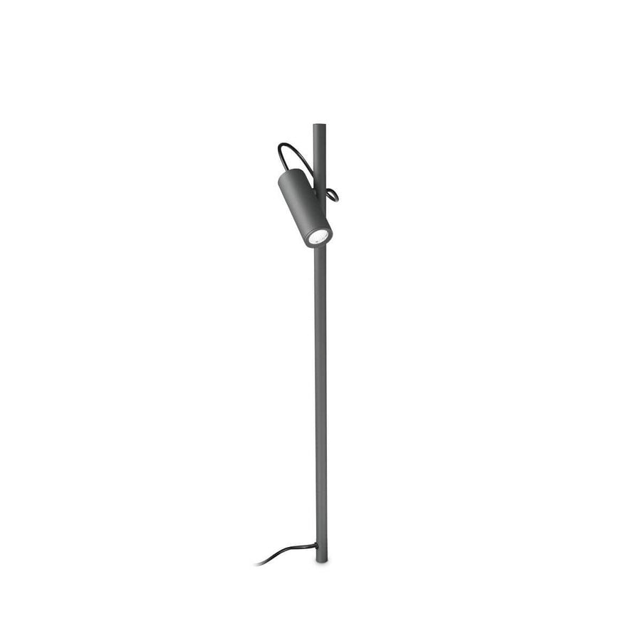 Lampadaire extérieur anthracite sur fond blanc, mât vertical et projecteur cylindrique suspendu.