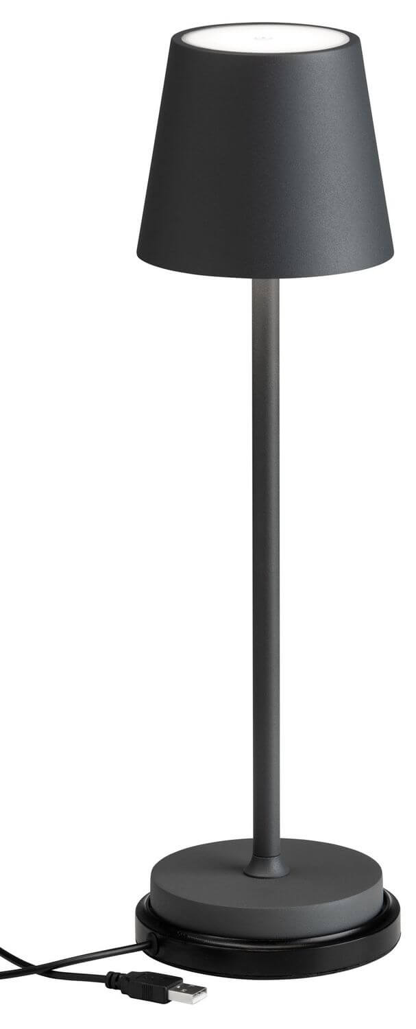 Lampe à poser présentée avec câble USB et base de recharge visible