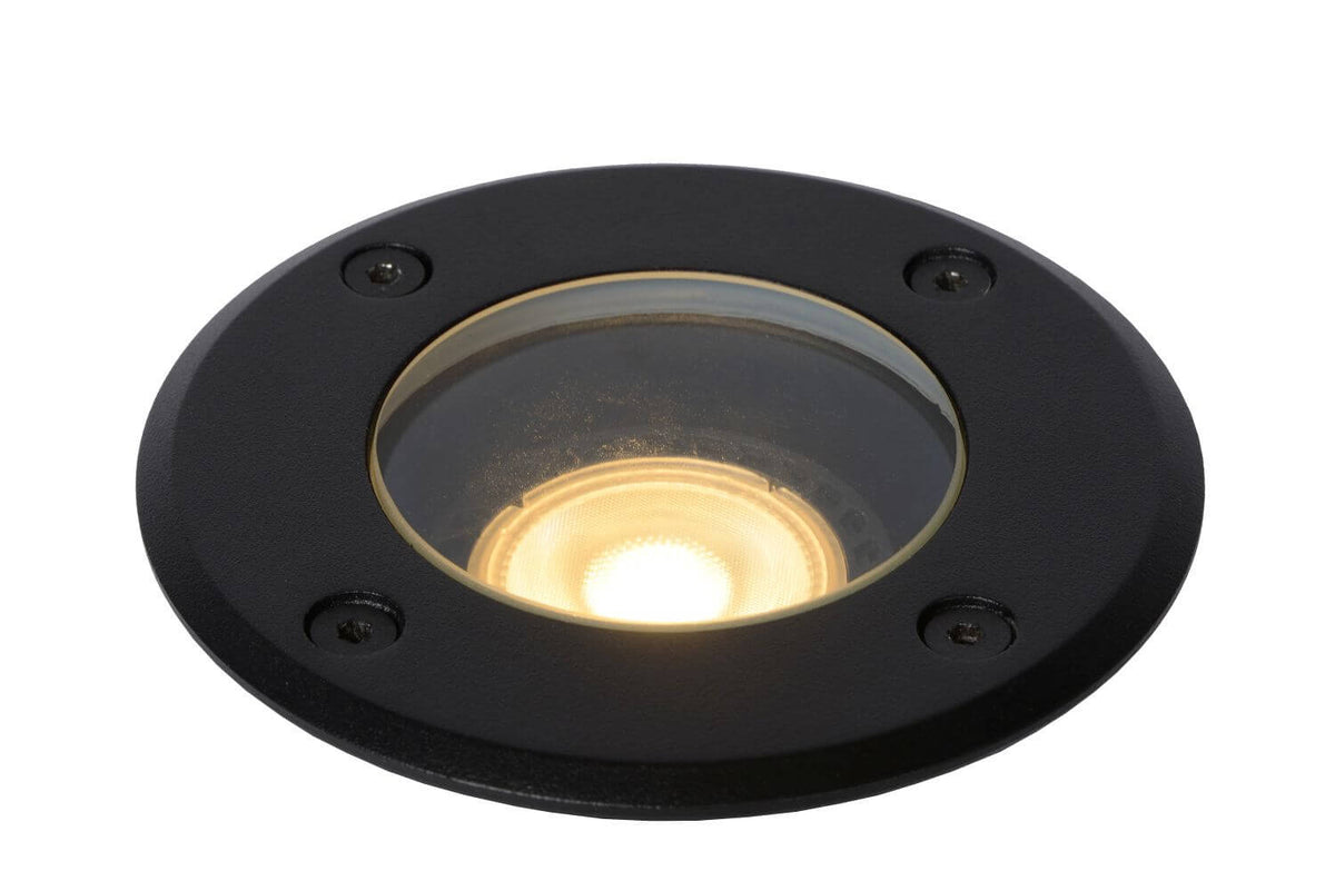 Détail de la lentille allumée sous verre transparent, finition noire et lueur dorée