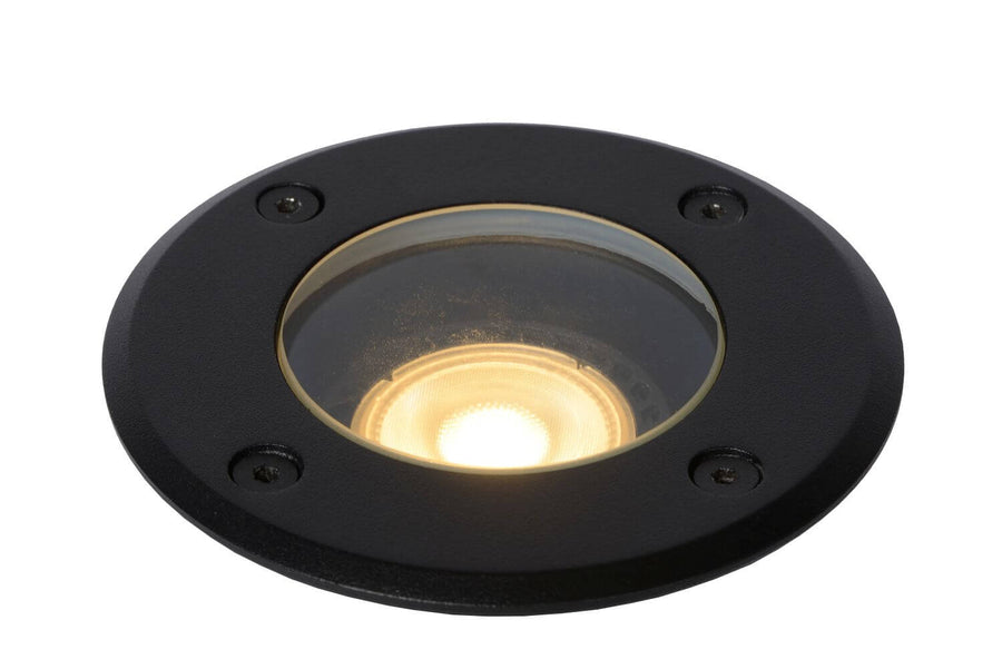 Détail de la lentille allumée sous verre transparent, finition noire et lueur dorée