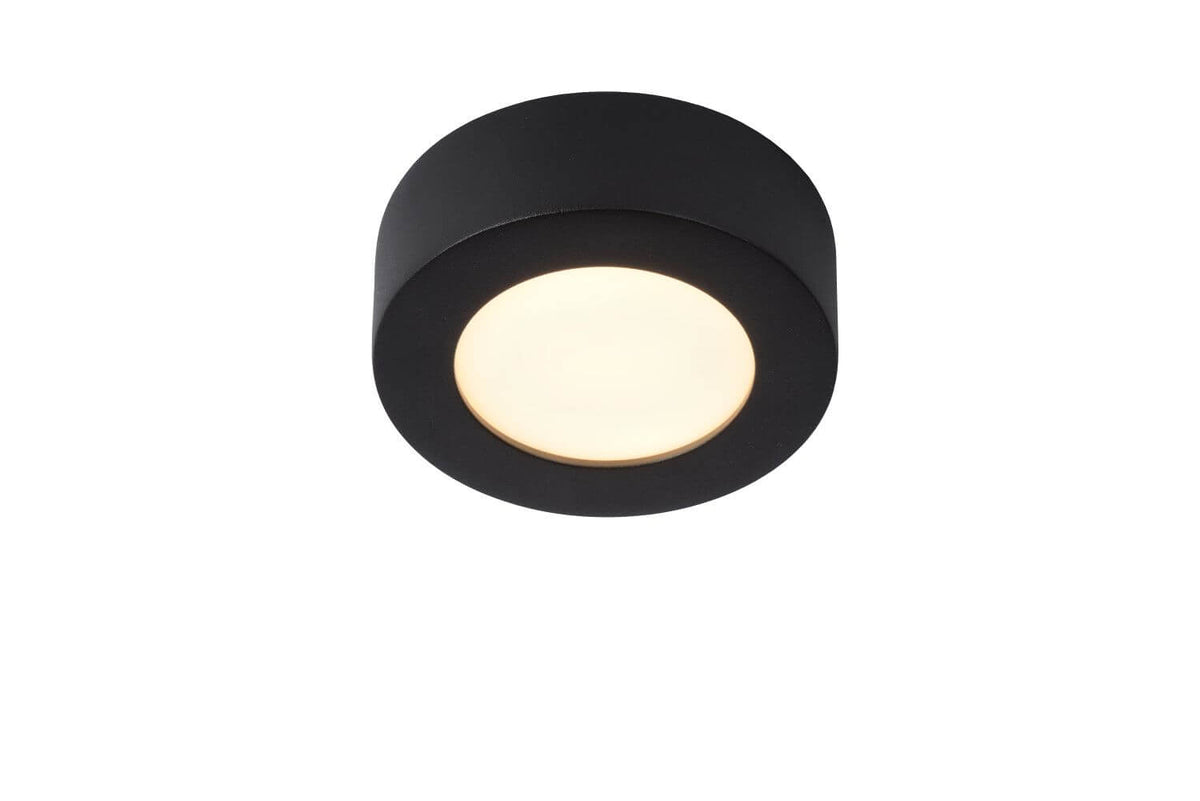 Produit isolé sur fond blanc montrant le plafonnier cylindrique noir allumé avec diffuseur opale.
