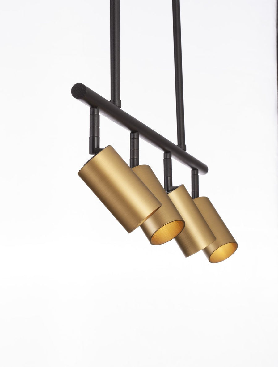 Gros plan sur les quatre cylindres dorés orientables sous la barre noire