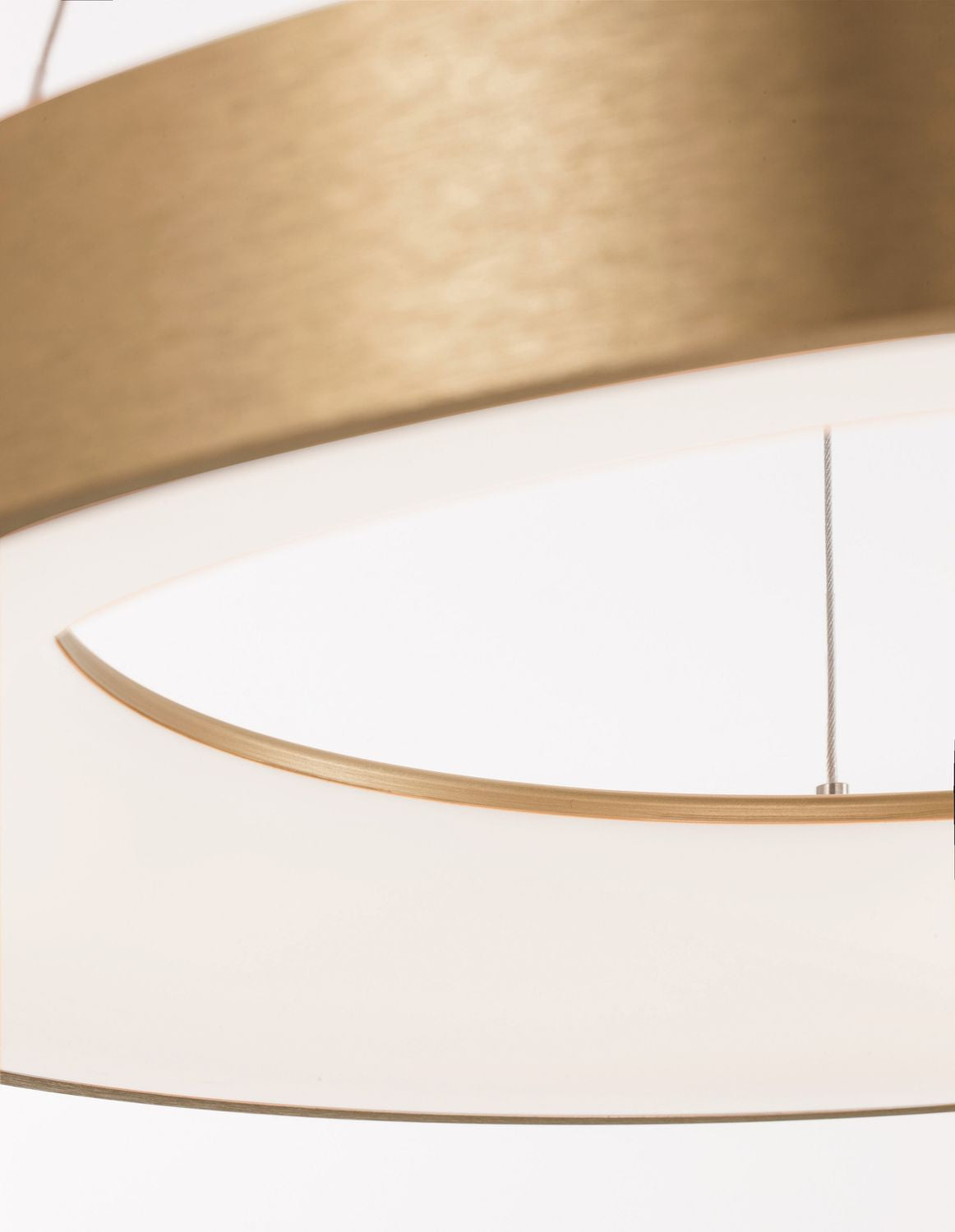 Détail oblique montrant l'anneau intérieur doré et la surface lumineuse blanche