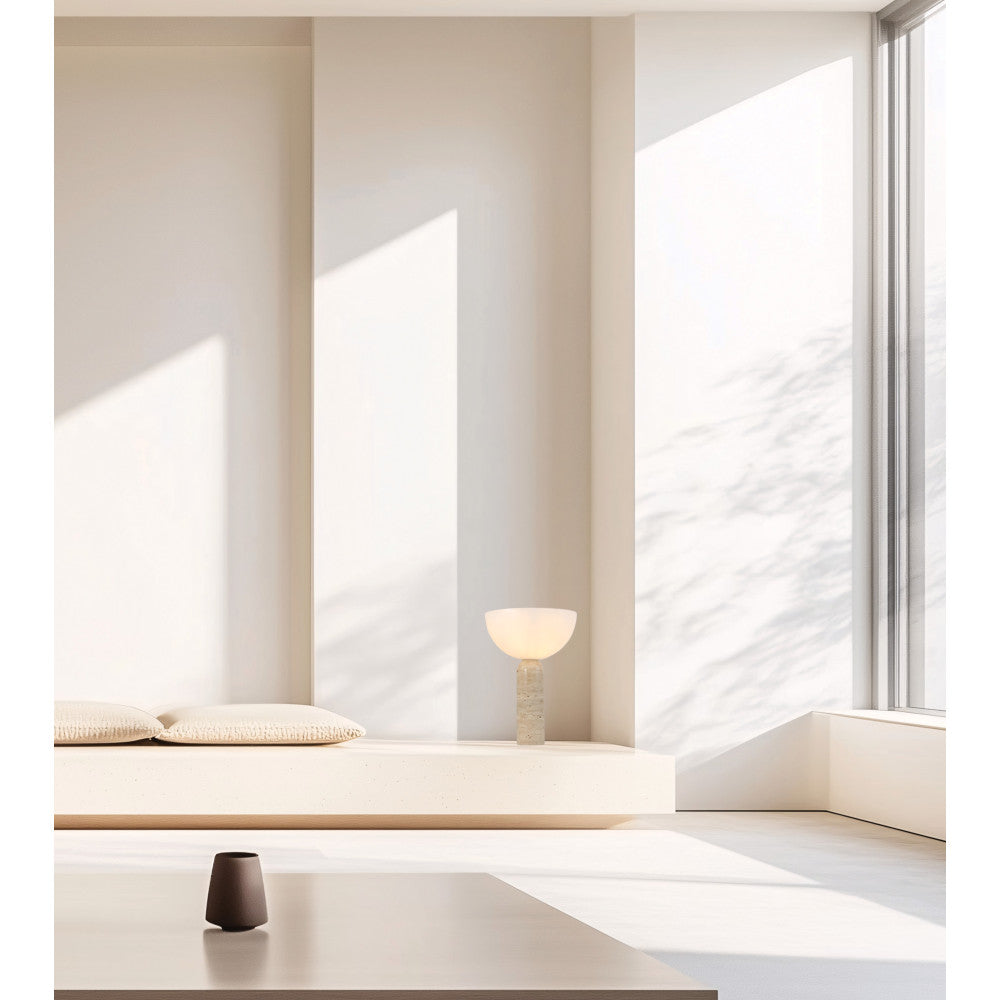 Lampe posée sur un banc blanc dans un intérieur minimaliste baigné de lumière