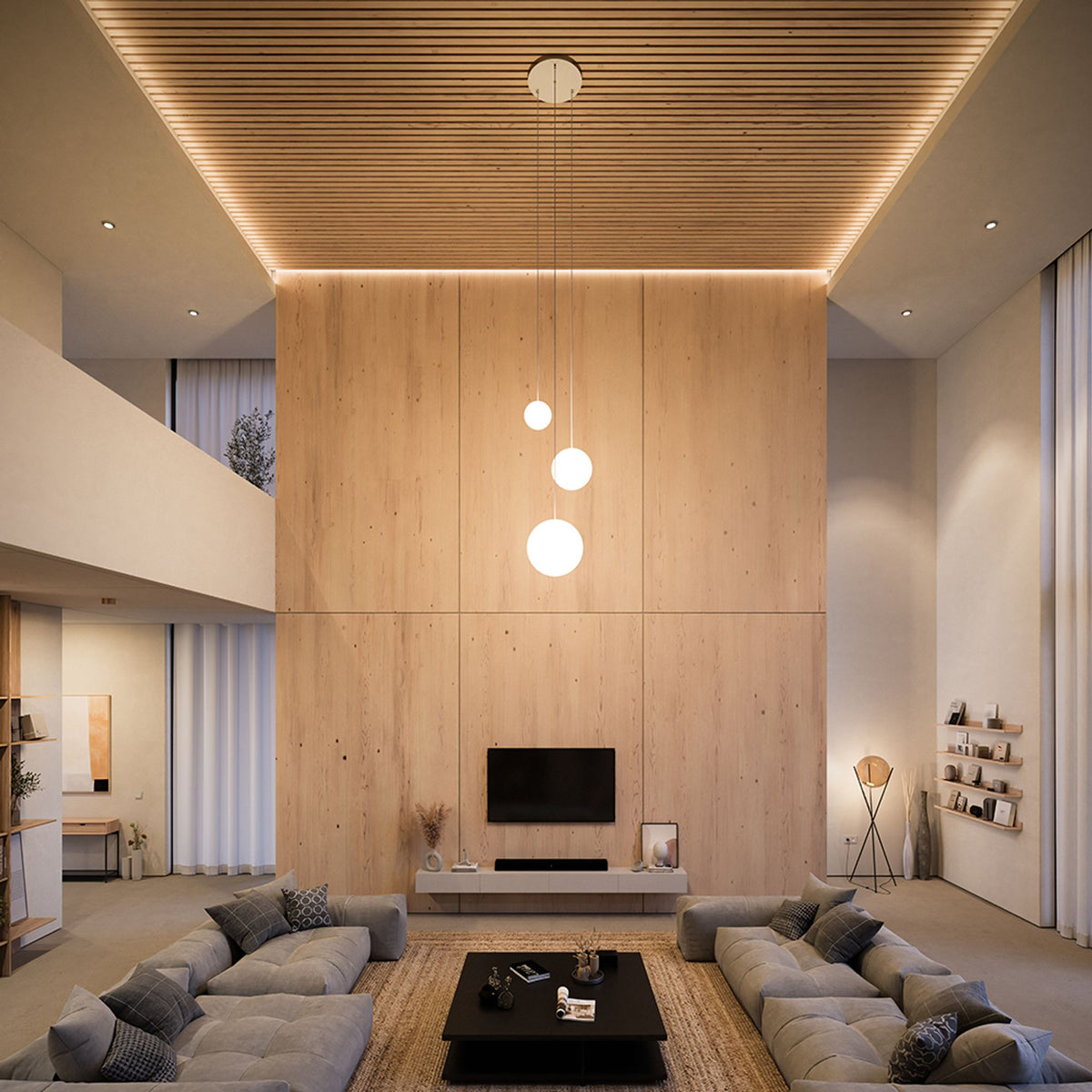 Vue d'ensemble dans grand salon, trois globes opalins suspendus à hauteur variable.