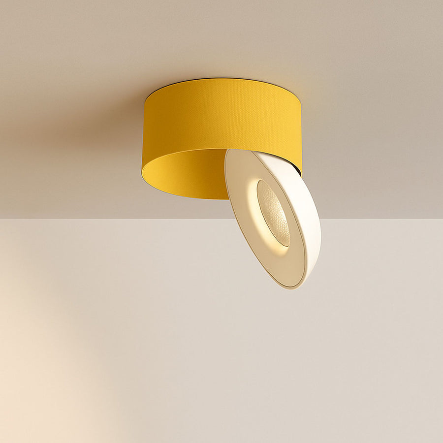 Spot cylindrique jaune moutarde fixé au plafond, projecteur rond incliné vers le bas
