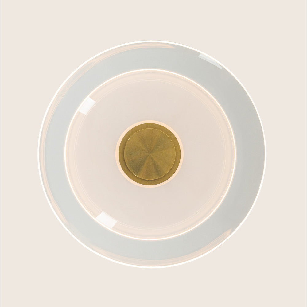 Vue de dessous montrant le disque de verre transparent et la pastille laiton