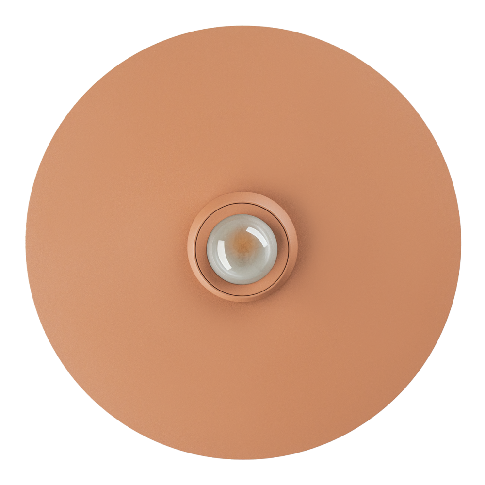 Vue de dessous du disque rouge brique avec lentille centrale en verre bombé