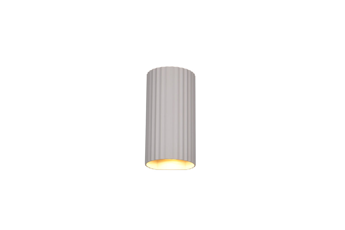 Gros plan sur la partie inférieure allumée diffusant une lumière dorée sous le cylindre.
