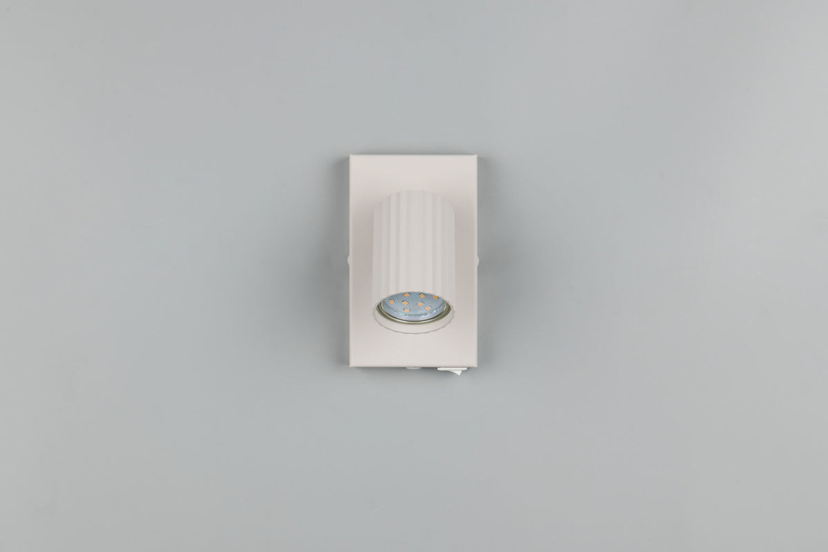 Vue de face du spot blanc avec module LED apparent sous la tête cylindrique.