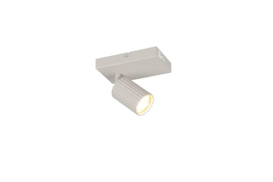 Vue en plongée du spot blanc fixé au plafond, tête cylindrique orientée vers le bas.