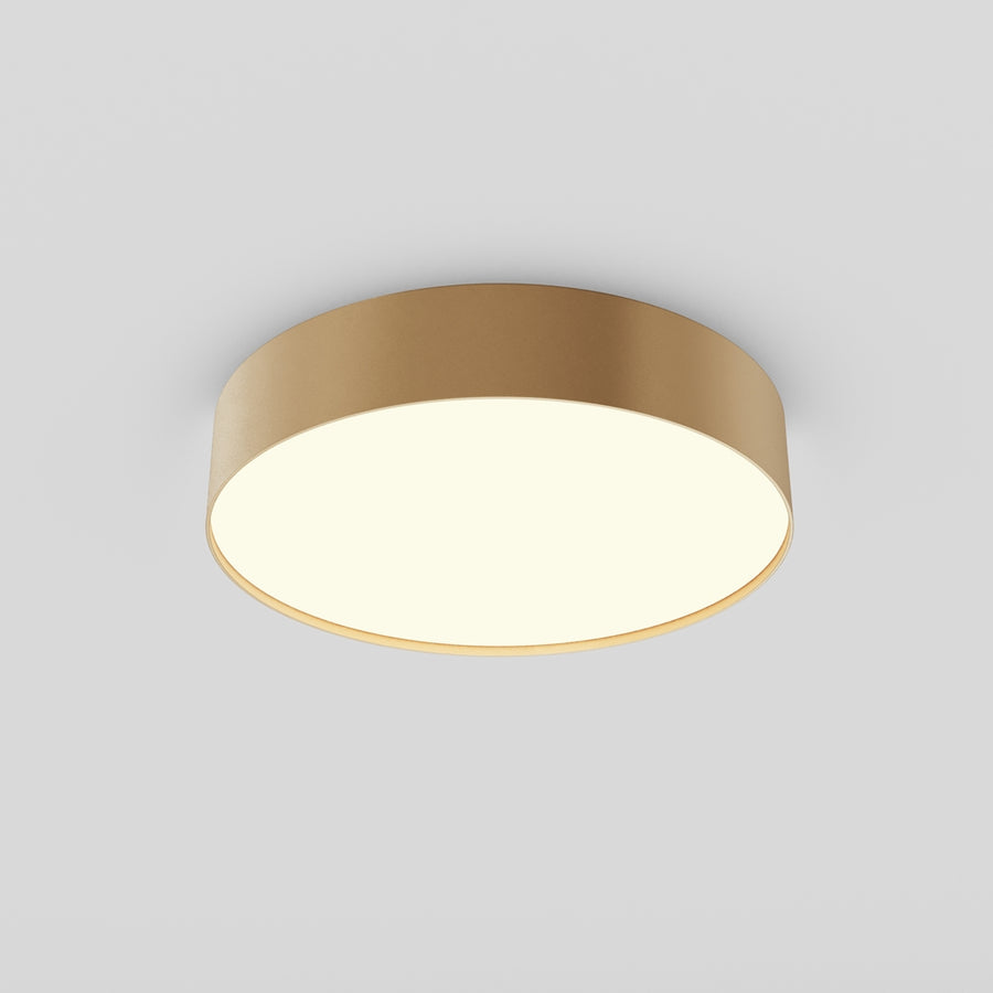 Plafonnier doré cylindrique vu de dessous en perspective, diffuseur blanc allumé